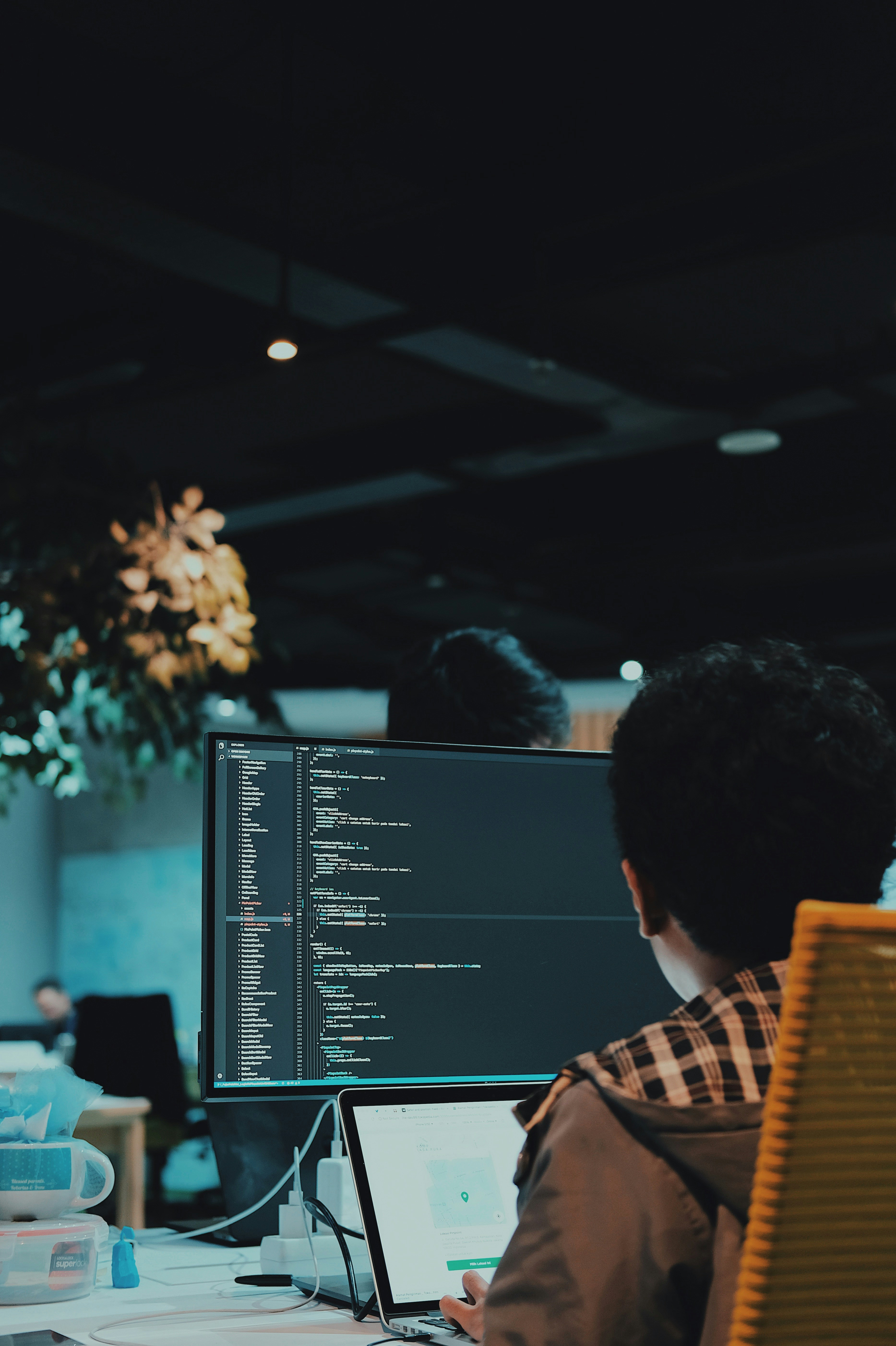 Engineer looking at code on a computer monitor